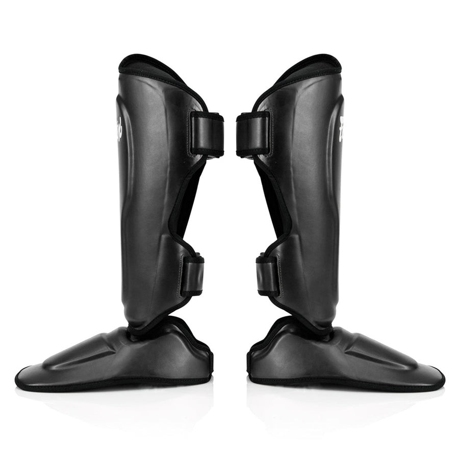 Fairtex SP9 -säärisuojat tarjoavat ylivoimaista suojaa ja mukavuutta. Fairtexin säärisuojat kuvattu sivusta, mustat. Innovatiivinen uusi kiinnitys, laajennettu suoja säärille, jalkapöydälle ja varpaille.